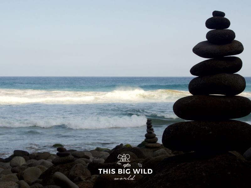 Iconic stacked rocks at Hanakapi'ai Beach along the Kalalau Trail in Kauai.