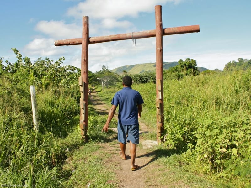 Image of my guide walking barefoot during a tour of a village on Nacula Island in Fiji.