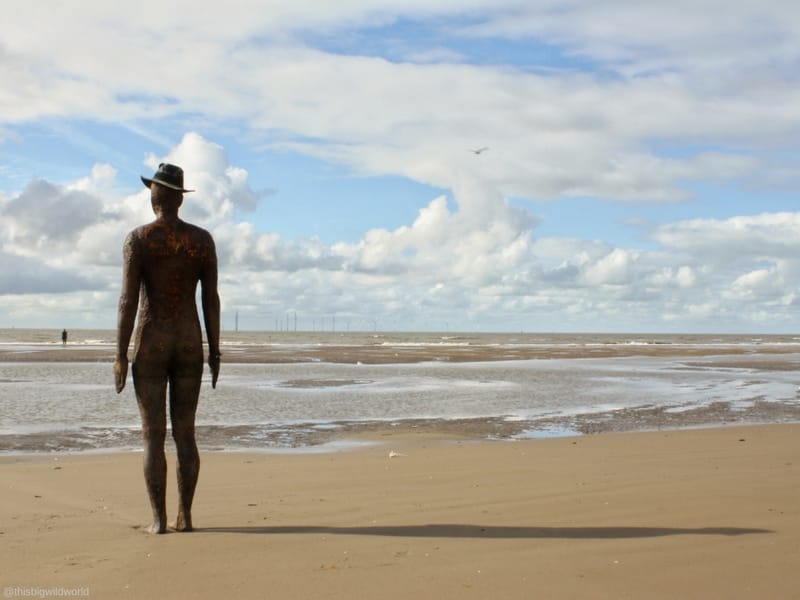 Image of Antony Gormley statue silhouette installed at Crosby Beach near Liverpool in England.