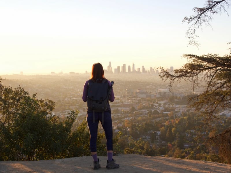 Image of me looking out at downtown LA from the trails at Griffith Observatory at sunrise.