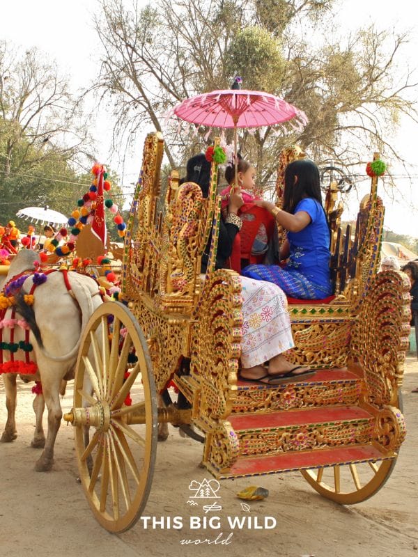 A golden carriage for the Shinbyu celebration carries a young boy through the village in Bagan.
