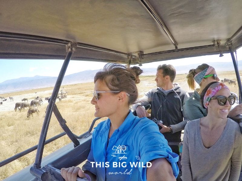 Four people standing up inside a safari jeep in Ngorogoro Crater. 