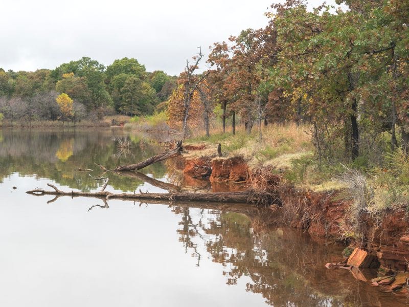 Enjoy the bright fall colors at Lake Thunderbird State Park in Oklahoma. Photo by Niki from Chasing Departures.