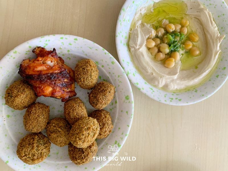 Across the street from Amman's Roman Amphitheater are several restaurants with affordable local cuisine, including hummus and falafel.