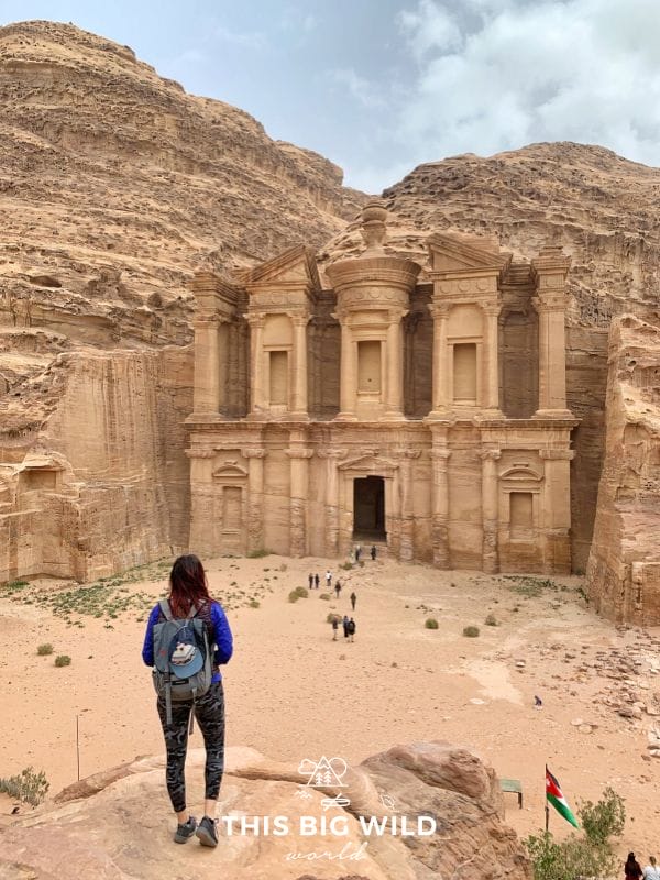 When you visit Petra, wear comfortable shoes and layers to protect you from the wind and sun. Here I'm wearing athletic leggings, sneakers, and a hooded windbreaker while enjoying the view of the Monastery.