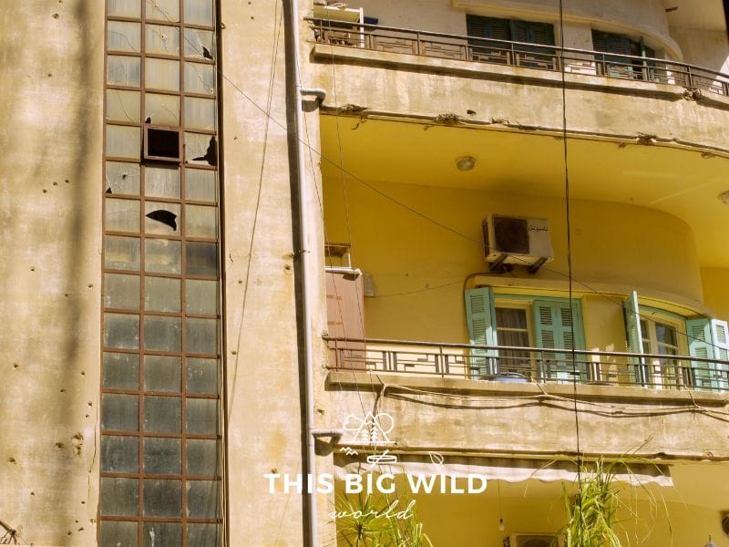 Bullet holes and broken glass in occupied apartment buildings are remnants of past conflict in Beirut.