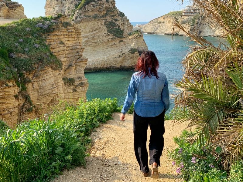 Walking down a dirt path to view the Corniche rock formation from a different angle.