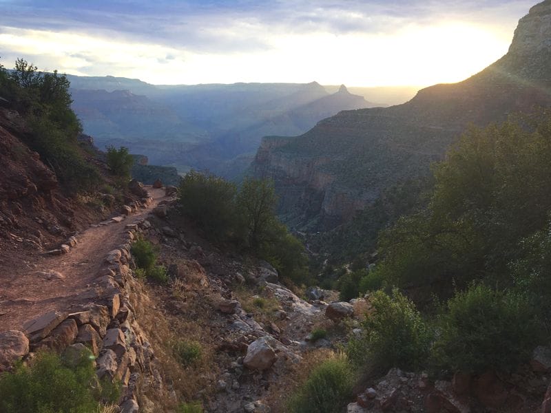 The Bright Angel Trail in the Grand Canyon is beautiful at sunrise as the sun peeks over the edge of the canyon. Photo Credit: The Detour Effect