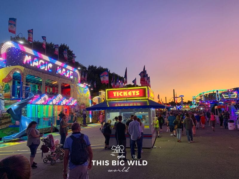 The sky just after sunset at the Minnesota State Fair is colored like cotton candy as the Midway games and rides light up for the evening.