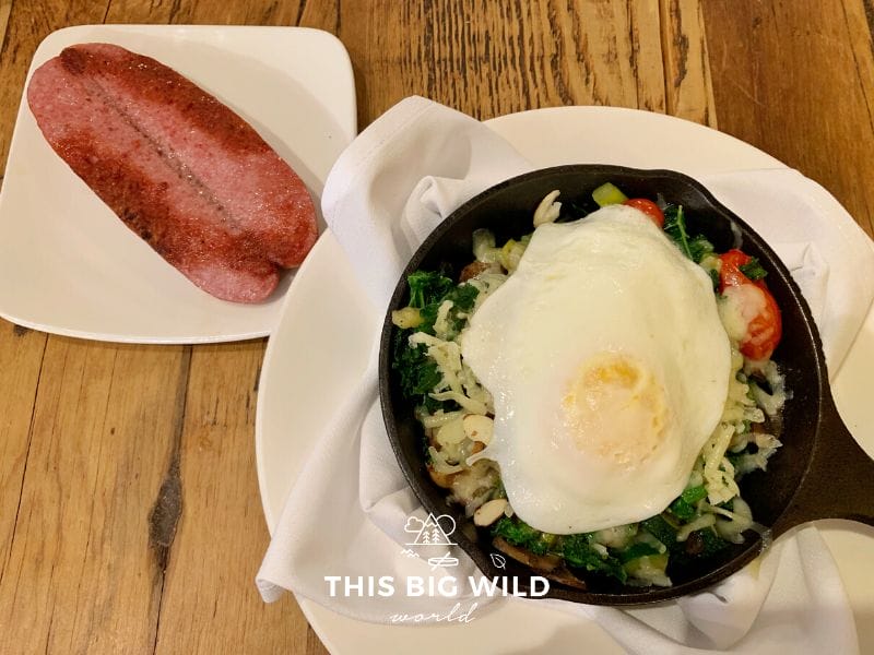 Gluten free kale sausage bake with a fried egg and a side of reindeer sausage from The Red Chair Cafe in Anchorage.
