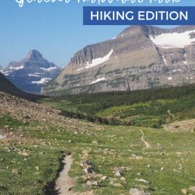 Text: What to pack for Glacier National Park - Hiking Edition Image: A narrow hiking trail extends off into the distance where there are snow covered mountains.