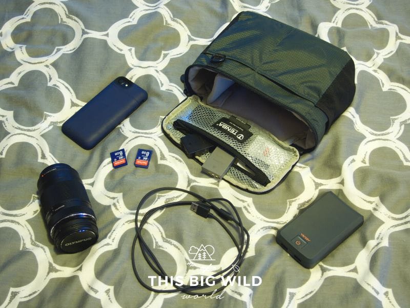 Pack essential camera gear for the Inca Trail, including zoom lens, extended battery pack for your phone, memory cards, extra camera batteries, phone charging cable, power bank, and camera insert.