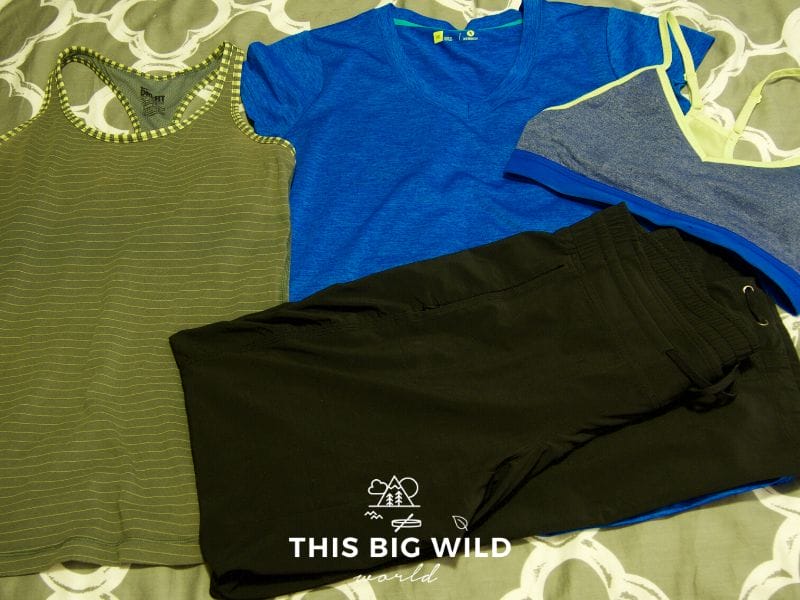 Image of clothing to include on your Inca Trail packing list, including a tank top, a lightweight v-neck t-shirt, and breathable pants.