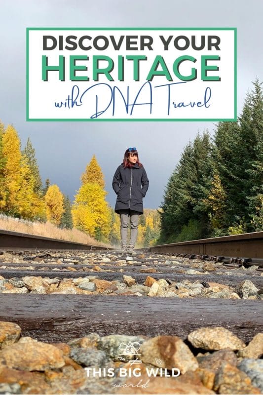 Text: Discover Your Heritage with DNA Travel Image: Me standing on an empty train track with yellow and green pine trees behind me and a cloudy sky overhead.
