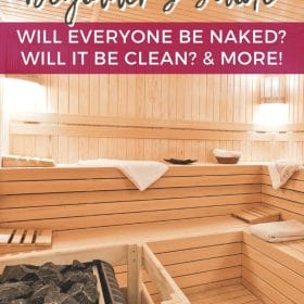 Text: Finnish Sauna Beginner's Guide - will everyone be naked? will it be clean? and more! Image: A clean, wood lined empty sauna with soft white lights and several white towels laying on the benches.