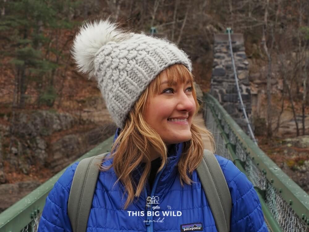 Woman wearing wool beanie while hiking.