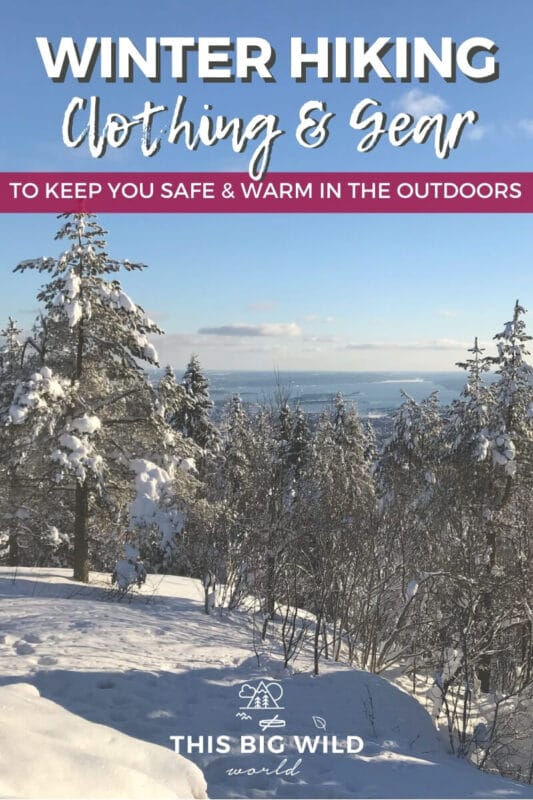 Text: Winter hiking clothing and gear to keep you safe and warm in the outdoors Image: Tall pine trees coated in snow on the side of a mountain looking out into the body of water on the horizon.