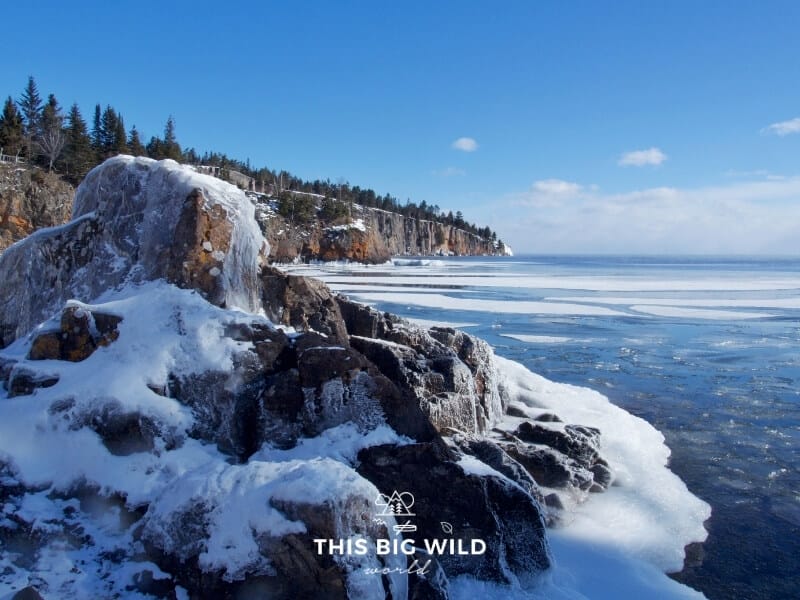 View of Minnesota's rocky north shore covered in ice and snow as viewed from Tettegouche State Park near Two Harbors MN.