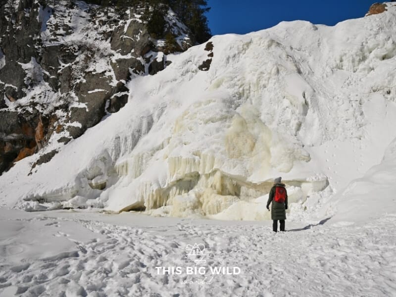 Me standing right in front of a frozen High Falls at Tettegouche State Park near Two Harbors Minnesota in winter.