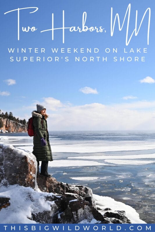 Text: Two Harbors MN, winter weekend on lake superior's north shore Image: Me in puffy green jacket and gray hat standing on an icy rock along the rugged shoreline of Lake Superior in winter