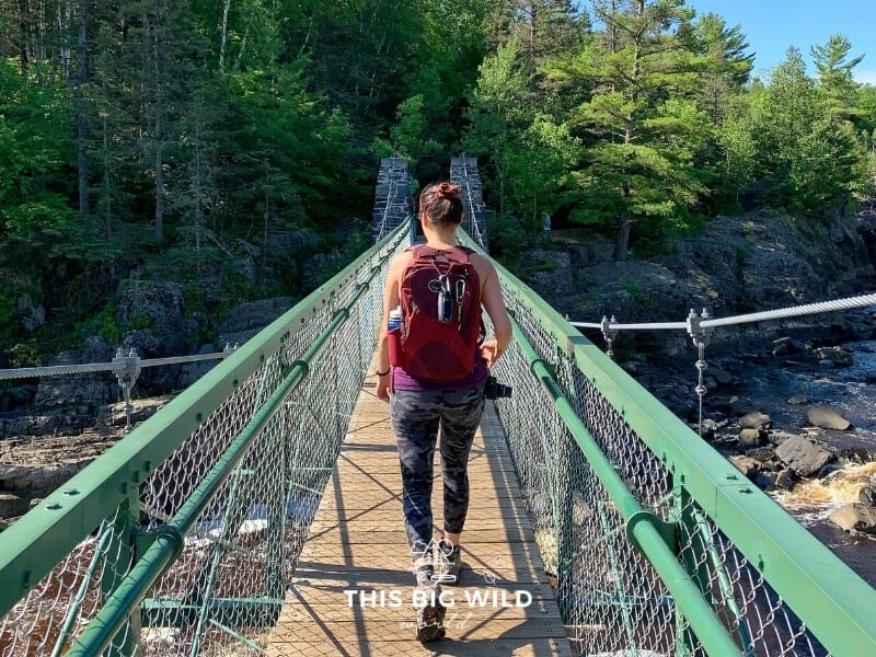 Me wearing a red Osprey daypack while hiking in summer in Minnesota.