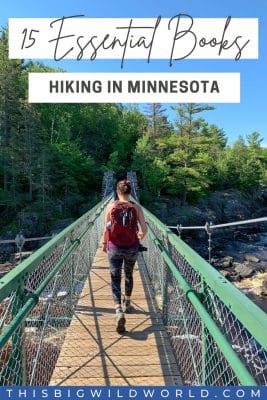 Text: 15 Essential Books Hiking in Minnesota Image: Woman walking away from camera over a suspension bridge wearing hiking gear.