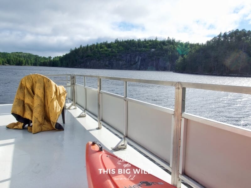 Yellow Rumpl nanoloft blanket is draped over a chair on the upper deck of a houseboat in Voyageurs National Park.