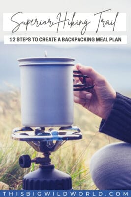 Text: Superior Hiking Trail: 12 steps to create a backpacking meal plan. Image: Closeup of a hand holding a backpacking stove with nature behind it.