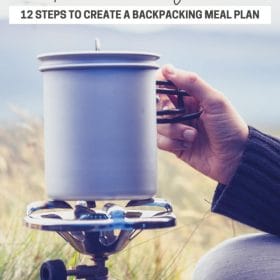 Text: Superior Hiking Trail: 12 steps to create a backpacking meal plan. Image: Closeup of a hand holding a backpacking stove with nature behind it.