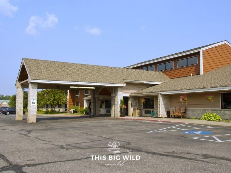 The Americinn by Wyndham hotel in Proctor with a large covered carport and plenty of parking space for large vehicles and equipment like snowmobiles.