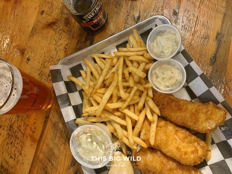 Golden fried fish and french fries on a metal tray with cole slaw and tartar sauce in Hayward Wisconsin.