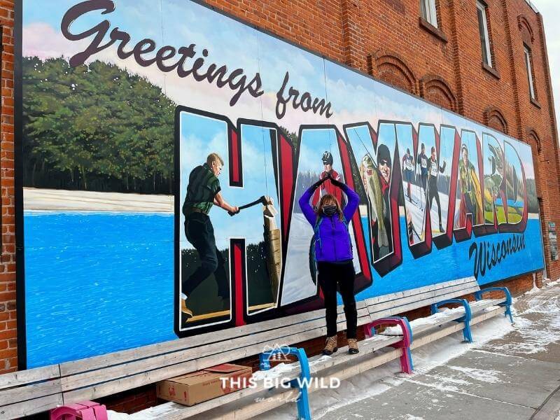 Mural on historic Main Street that says 'Greetings from Hayward' in Hayward Wisconsin.