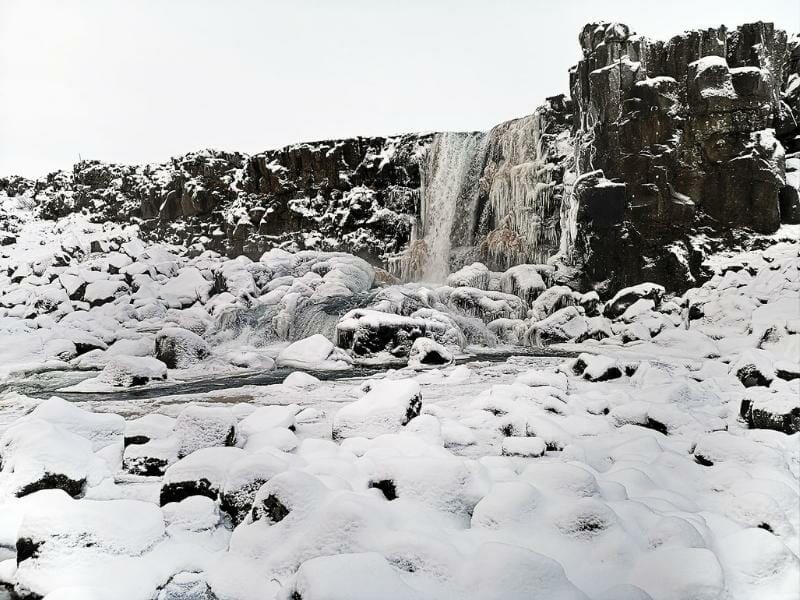 Chase frozen waterfalls in Iceland for a perfect cold weather holiday.