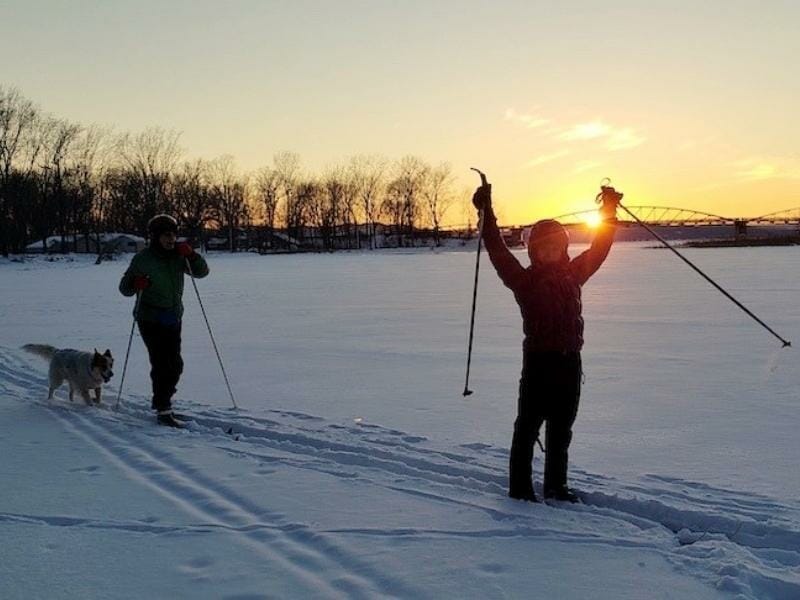 Cross country skiing across a frozen lake in Vermont at sunset.