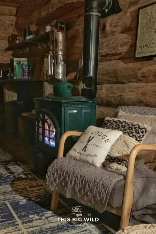 Read a book next to the propane fireplace in the winter at Ely Log Cabin!