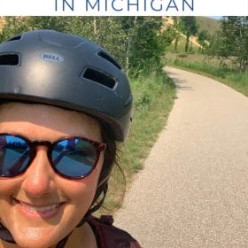 Best of Sleeping Bear Dunes in Michigan with image of me riding a bike next to sand dunes.