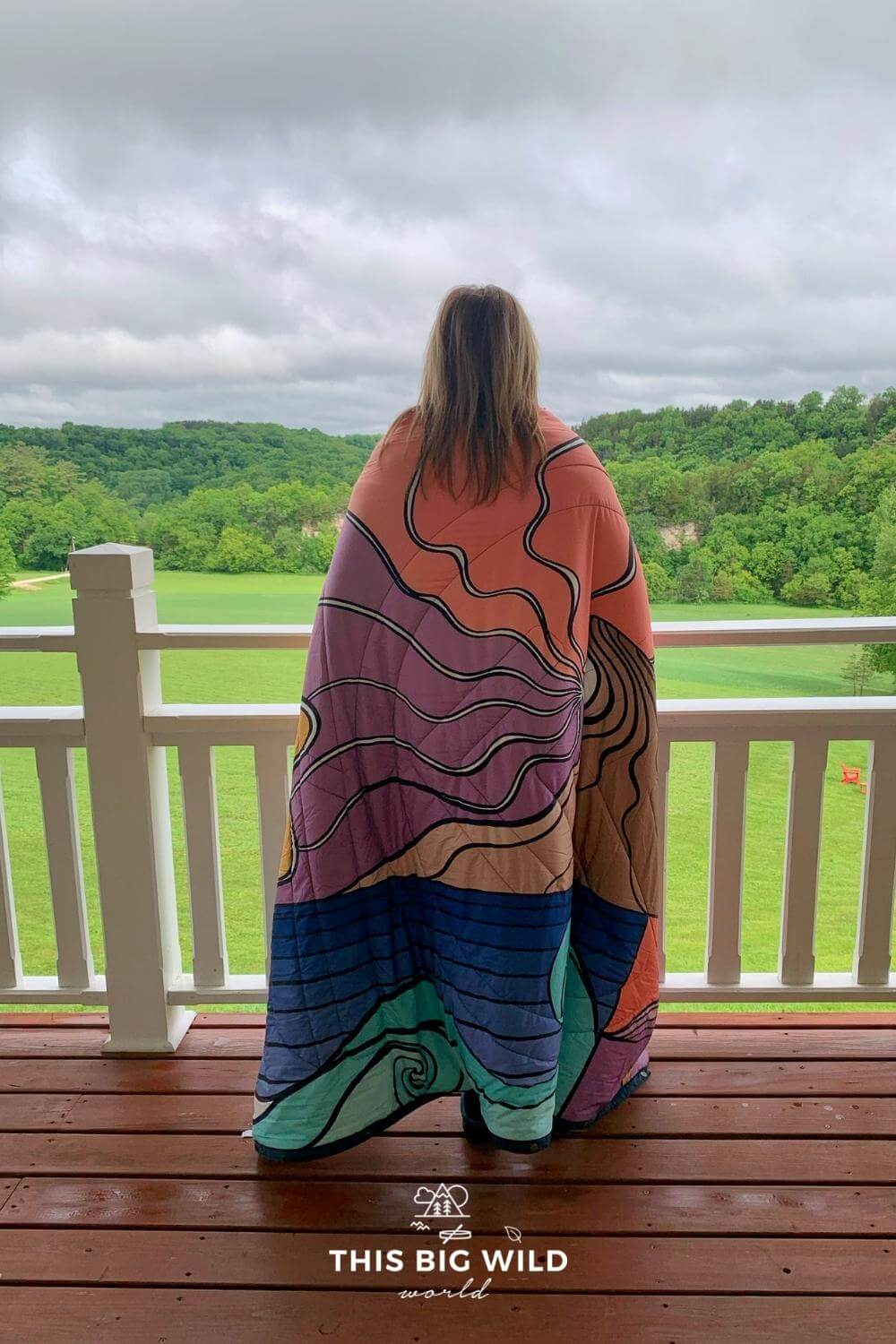 Me wrapped in a blanket looking out at the bluffs from the porch at Sacred Clay Country Inn in Lanesboro MN.
