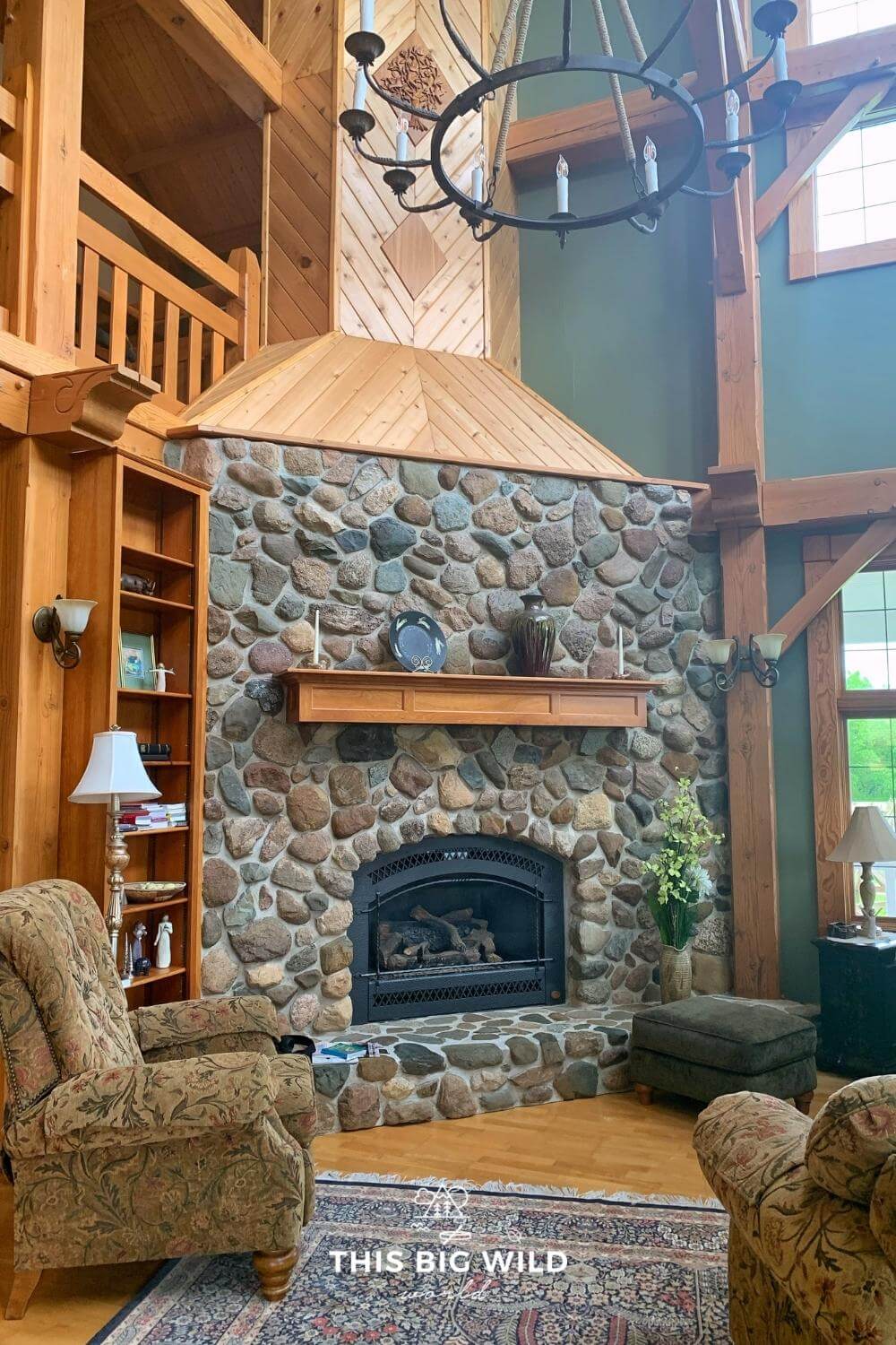 Stone fireplace surrounded by intricate wooden detail in the living room at Sacred Clay Country Inn in Lanesboro MN.