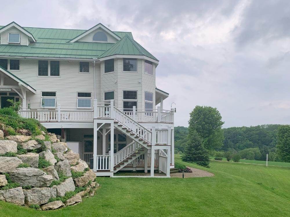 Sacred Clay Country Inn is a large white home that sits on top of a hill overlooking bluff country in Lanesboro MN.