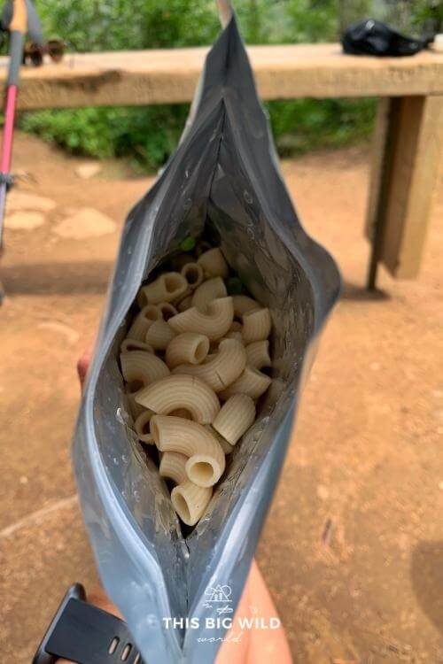 Pasta partially rehydrated in a foil pouch on the backpacking trail.