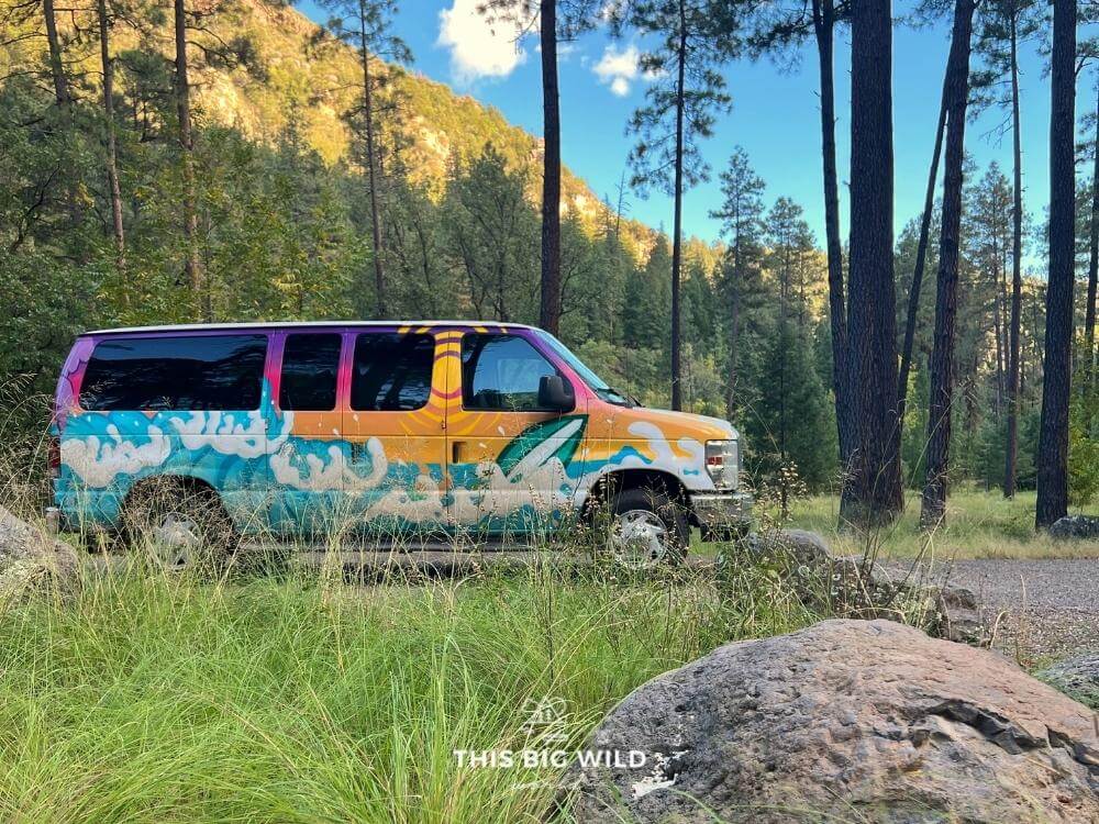 Colorful campervan parked at a campsite in a pine a forest near Sedona.