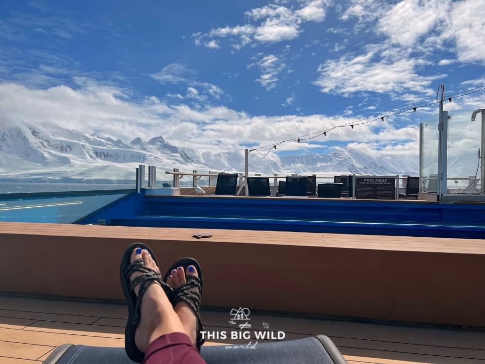My feet in sandals and joggers on the deck of the ship in Antarctica.