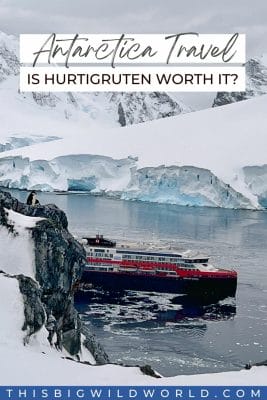A cruise ship in Antarctica as seen from above with glaciers and mountains in the distance.