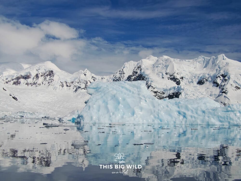 A giant iceberg floats in a channel in Antarctica.