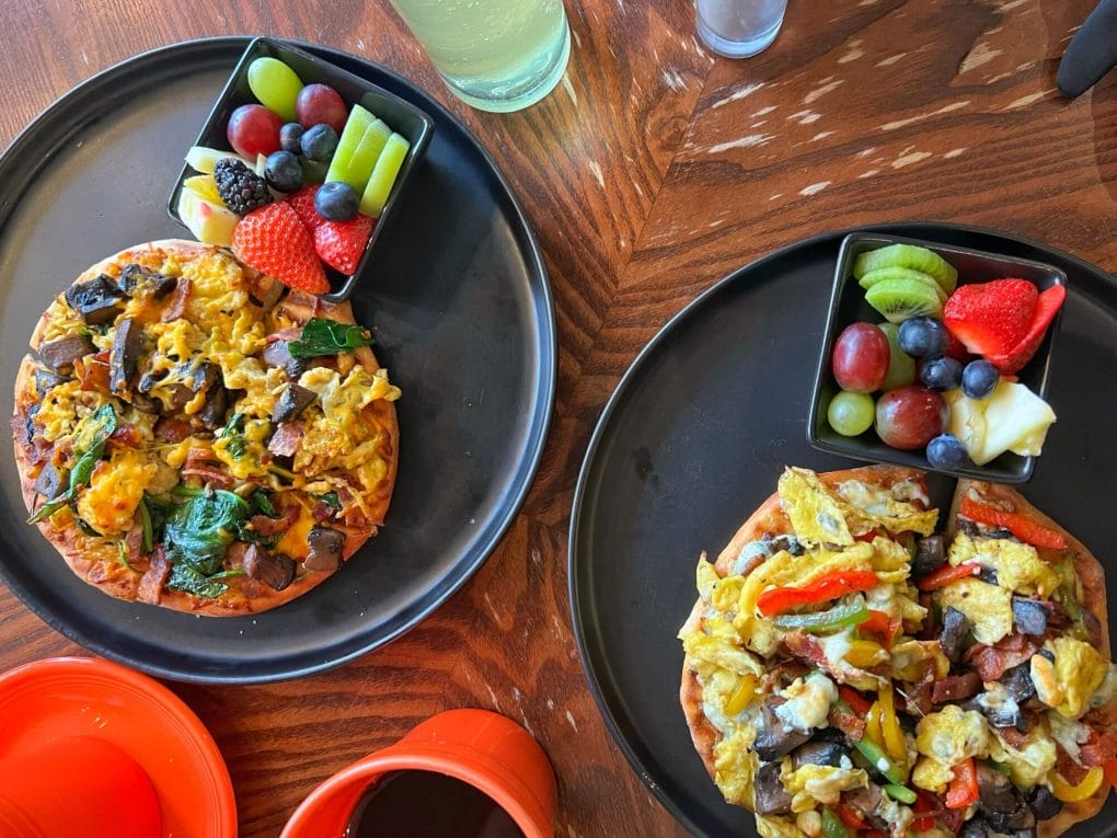 Two breakfast pizzas with coffee and kombucha at Jules' Bistro in St Cloud MN.