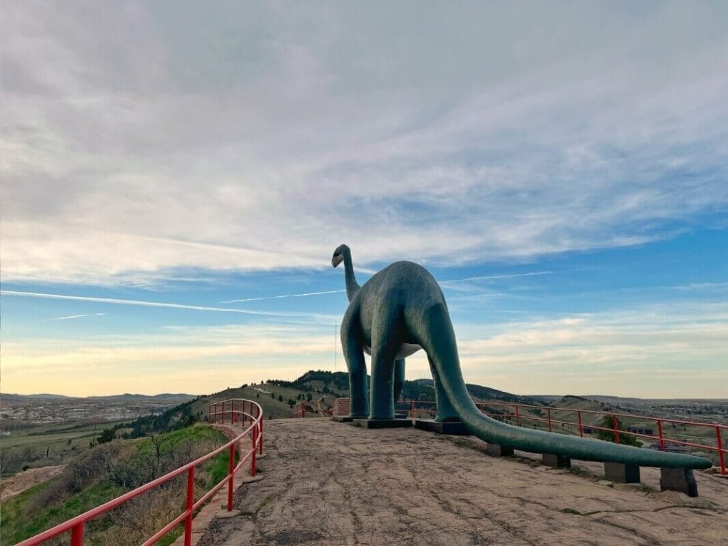 Life-size statue of a dinosaur at sunset at Dinosaur Park in Rapid City