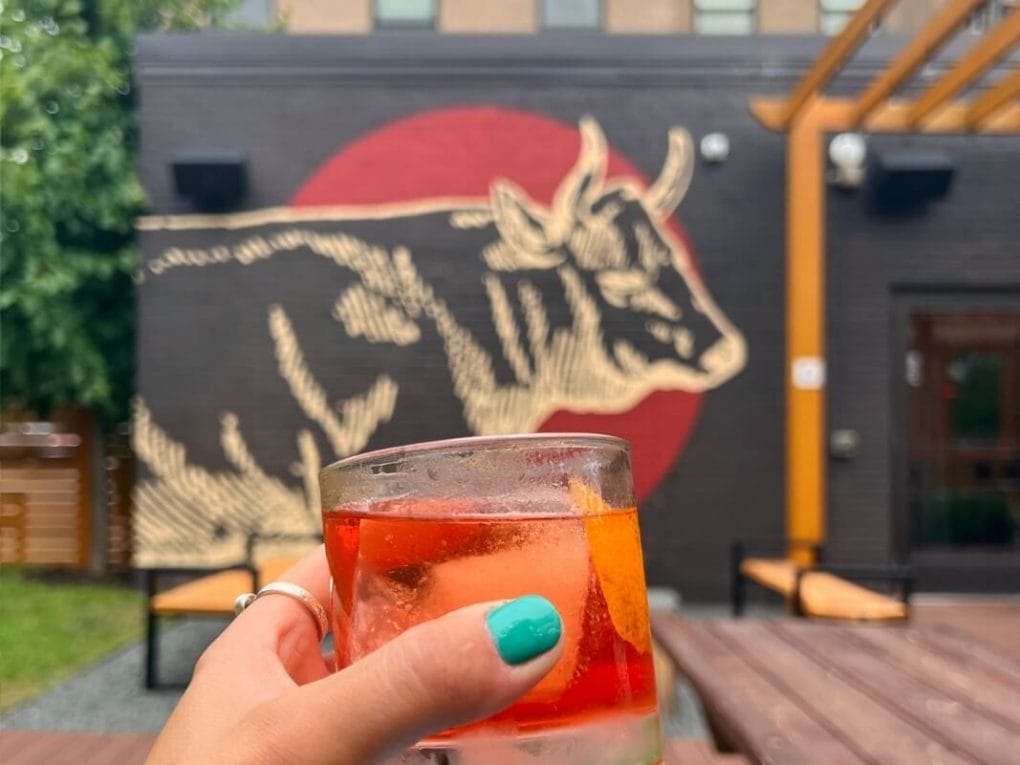 Sipping a bourbon old-fashioned on the patio at The Lakely in Eau Claire WI
